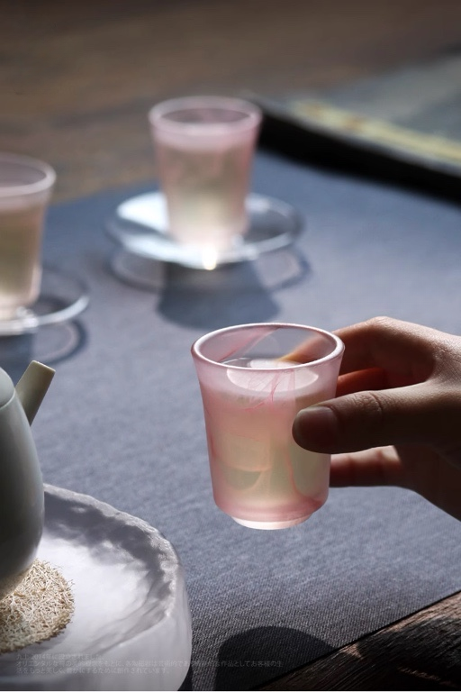 Hand holding "Ink Wash" Glass Tumbler with unique ink wash pattern, perfect for tea, whiskey, or juice.