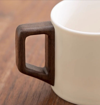 Close-up of "Half Sight" Coffee Cup with elegant wooden handle design.