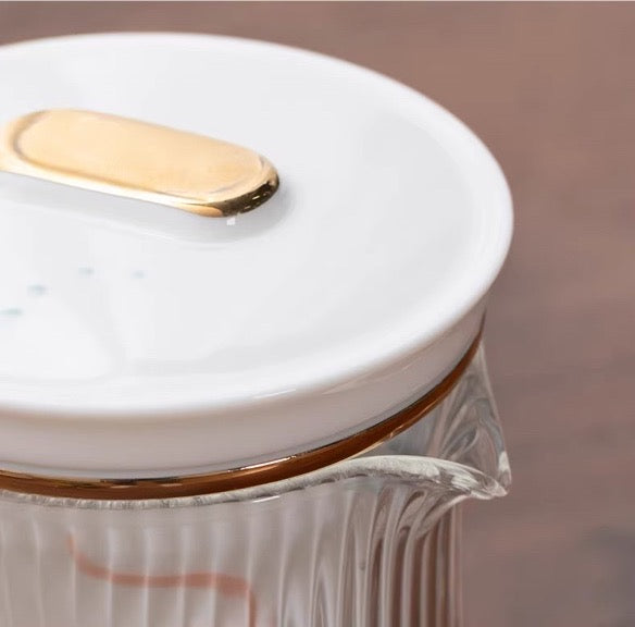 Close-up of a lid on the "Lotus" Portable Tea Set teapot with a sleek design and gold accent