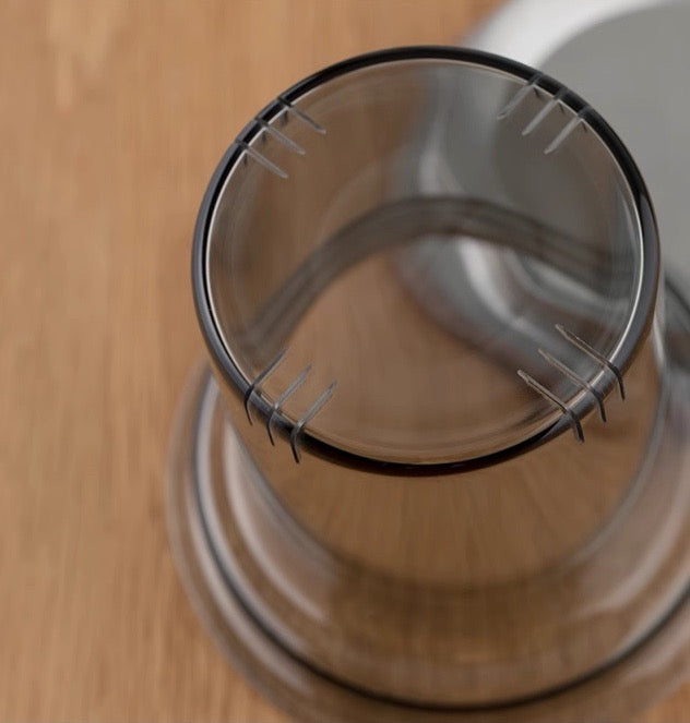 Close-up of "Deep Space" Tea Cup's built-in filter on a wooden surface for perfect tea brewing